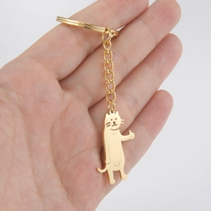 Minimalist 18K gold-plated stainless steel cat pendant keychain on palm