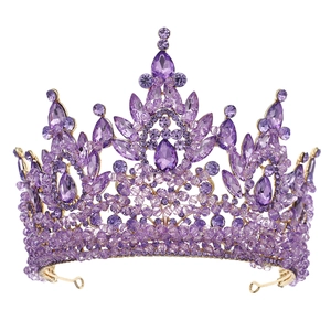 Detailed close-up of golden baroque tiara with purple crystals and luxury rhinestones