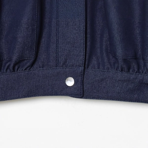 Dark blue denim bomber jacket showing stitching details and a silver metal button