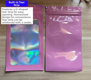 Pink mylar bags with U-shaped easy tear notch and holographic window on wood background