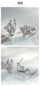 Detail view of vintage silver earrings with gothic cross design and zircon stone insets