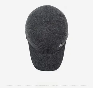 Detail of dark gray wool texture and silver R letter logo on the winter baseball cap side
