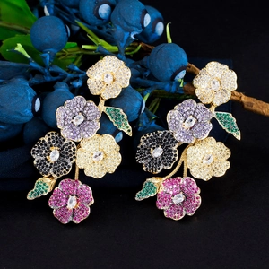 Elegant floral drop earrings with multicolored zircons on a dark berry background