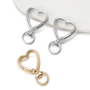 Detail of heart-shaped lobster clasps in gold and silver finish for DIY keychains