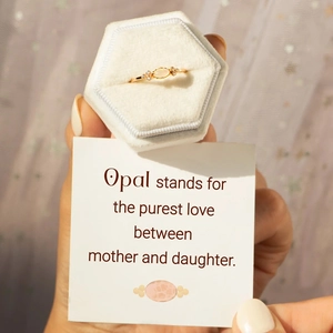 Detail of s925 silver opal ring in white velvet hexagon gift box with a message card