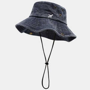 Detail of dark blue washed cotton bucket hat featuring white airplane embroidery and chin strap