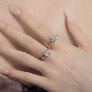 Detailed view of square cut cubic zirconia rings in gold and silver on model hands