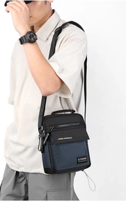 Vertical nylon messenger bag for men featuring adjustable shoulder strap and top handle