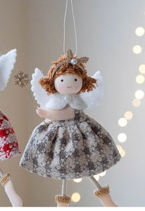 Detail of Christmas angel plush doll with grey plaid dress and golden snowflake wand