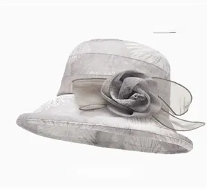 Detail of gray sun hat with delicate mesh flower and palm leaf patterns