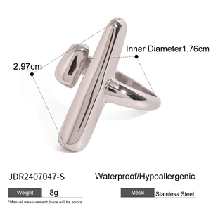 Macro view of geometric stainless steel ring with polished finish and crossed bar design