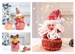 Detail of Christmas knitted gift bags with Santa, bear and reindeer plush characters