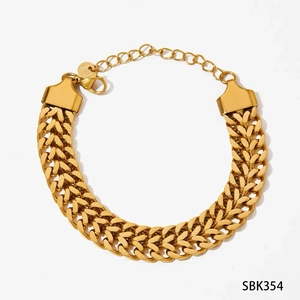 Detailed close-up of wide braided gold stainless steel bracelet with lobster clasp and tag