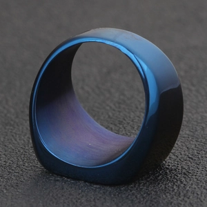 Polished blue stainless steel wing ring with laser engraved detail and curved design