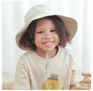 Detail of baby sun hat with wide brim and adjustable windproof chin strap