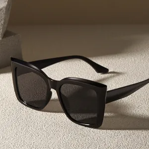 Oversized square cat-eye sunglasses in glossy black finish with a modern minimalist style