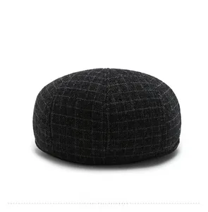 Detail view showing the back profile and classic plaid pattern of the wool flat cap