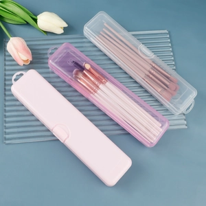 Clear and pink makeup brush storage boxes with secure snap locks on a blue background
