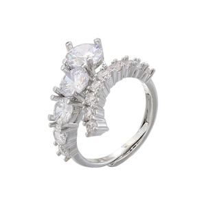 Macro shot of silver open ring with prong-set colorful crystals and polished finish