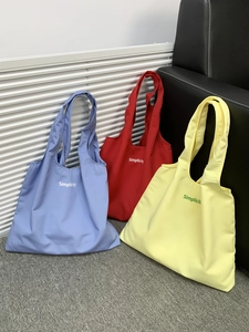 Minimalist canvas tote bag with Simplicity lettering in blue, red, and yellow colors