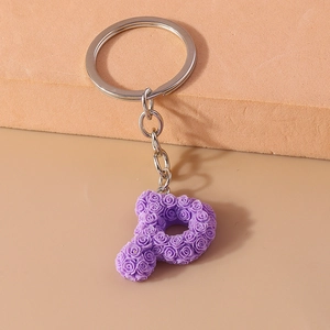 Detail showing letter P keychain with purple 3D floral roses and silver metal ring