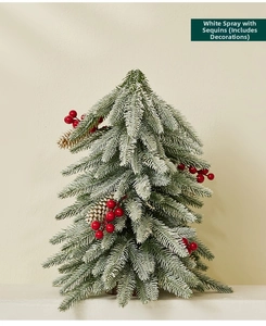 Close-up of 40cm mini snowy Christmas tree with red berries and natural pinecones