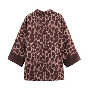 Detailed back view of a loose leopard print blouse featuring solid brown contrast cuffs
