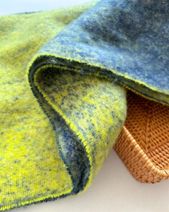 Close-up of thick blue and yellow gradient cashmere-like scarf with soft texture