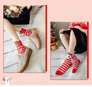 Close-up of festive red Christmas socks with reindeer patterns and plush 3D ear details
