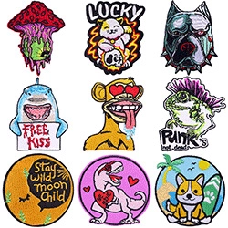 Macro shot of 9 assorted embroidered patches with punk animal and mushroom designs