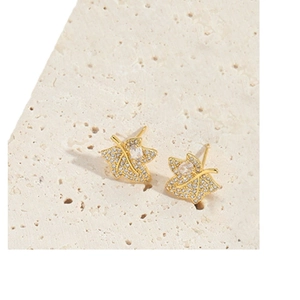 Exquisite gold maple leaf stud earrings featuring shimmering cubic zirconia on stone base