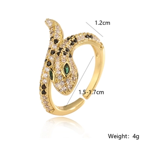 Detail shot of gold-plated snake ring with green stone eyes and clear zircon settings
