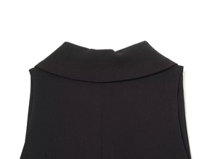Detail of notch lapel and shoulder on black woven mini blazer dress with high texture