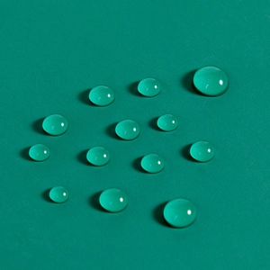 Close-up of waterproof green PU fabric showing excellent hydrophobic water droplet beads