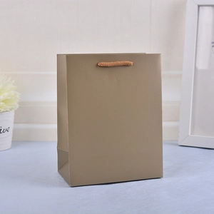 Minimalist brown kraft paper shopping bag with sturdy twine handles for retail and gifts