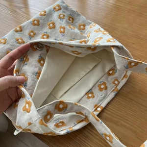 Detail view of floral canvas tote bag interior with magnetic clasp and inner pocket