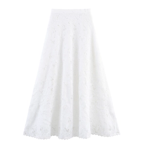 Detailed close-up of white A-line lace skirt with intricate floral hollow patterns