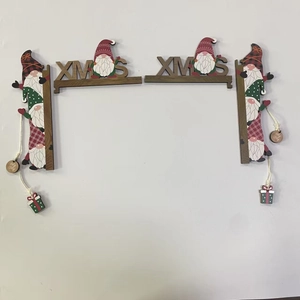 Detail of wooden Christmas gnome door corner decoration with XMAS and Holy Jolly text