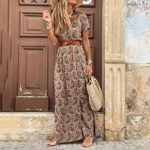 Bohemian paisley V-neck maxi dress with wide brown belt shown in vintage street setting