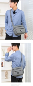 Gray nylon crossbody bag featuring multiple compartments and an adjustable shoulder strap