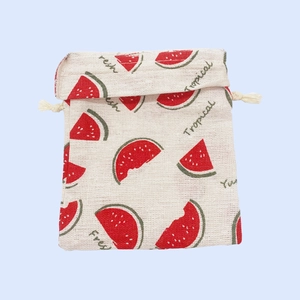 Detail of cotton linen drawstring bag featuring a fresh red watermelon tropical print