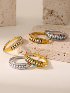 Detailed close-up of adjustable stainless steel rings with shell pearls and zircons