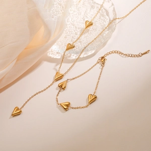 Elegant gold plated stainless steel heart pendant necklace on textured fabric