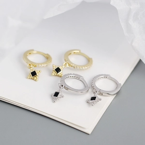 Macro shot of s925 silver stud earrings with black square pendants and small diamonds