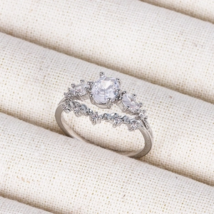 Detailed close-up of 18K silver ring with oval crystal and sparkling cubic zirconia stones