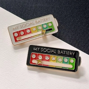 Detail of sliding social battery enamel pin showing metal slider and mood icons