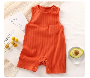 Close-up of orange ribbed cotton baby bodysuit featuring shoulder snaps and small chest pocket