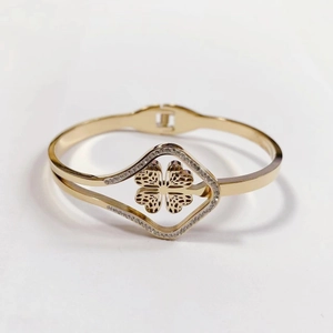 Elegant gold titanium steel clover bangle with sparkling crystals and open-end design