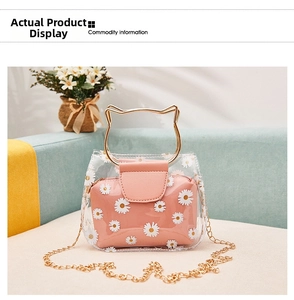 Detail of daisy print jelly bag with golden cat-ear handles and metal chain strap