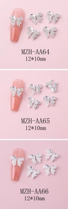 Macro detail of three bow-shaped nail charms with rhinestones and pearls on nail tips